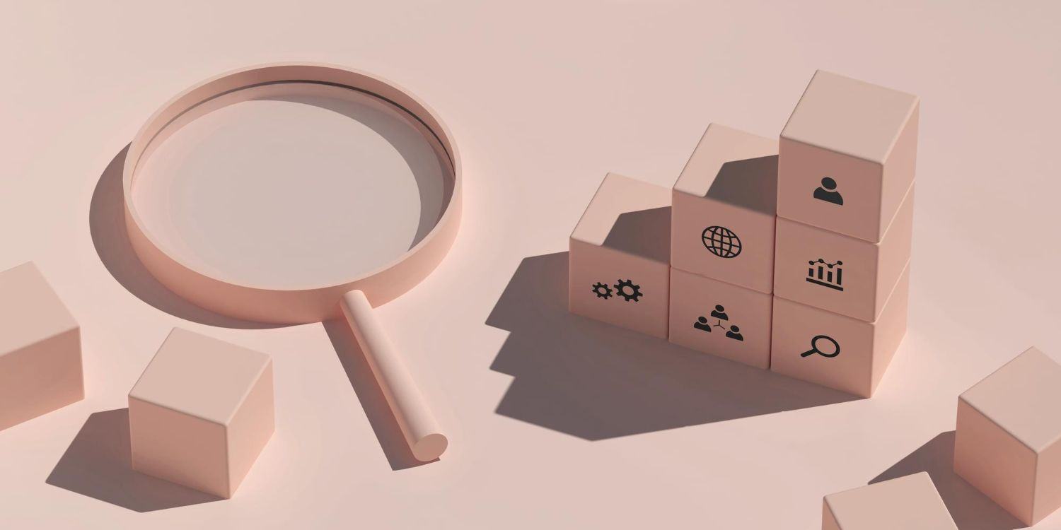 A magnifying glass beside stacked blocks printed with search and analytics icons